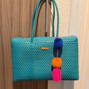Stylish Blue Woven Bag with Pom Poms